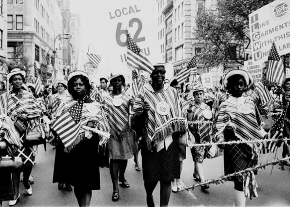 Historical photograph of early trade union members marching in solidarity